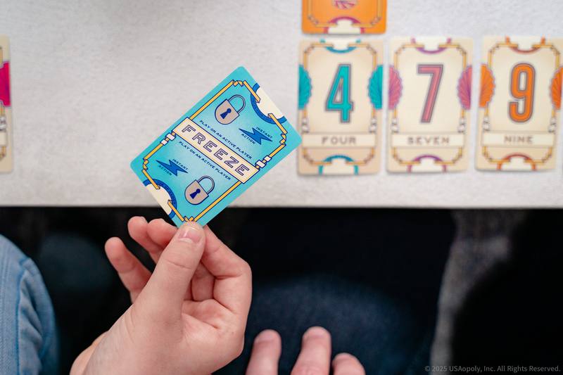 A player holding a Freeze card over a Flip 7 game