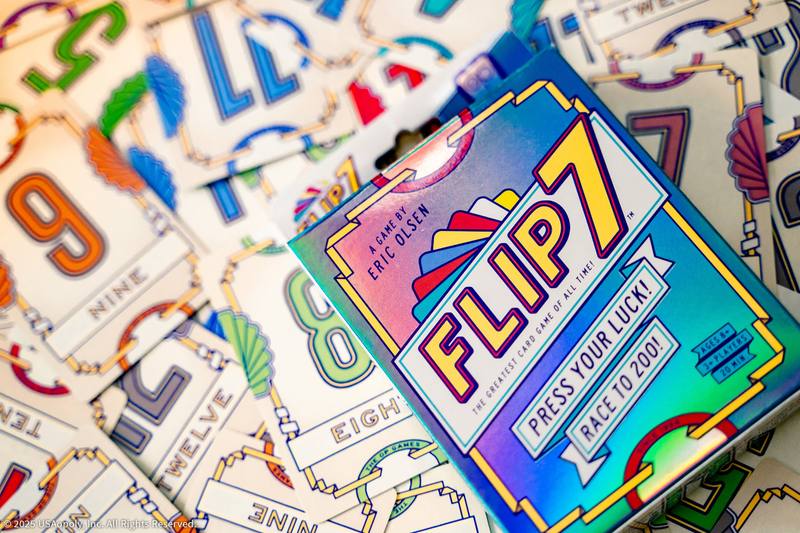 Flip 7 box resting on a spread of number cards