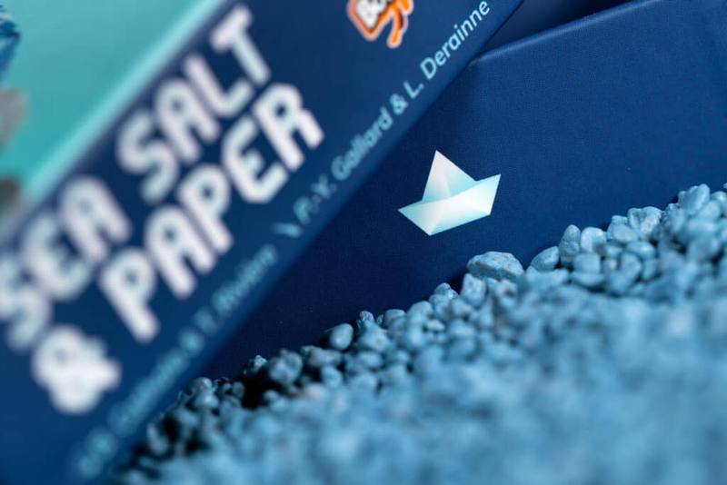 Sea Salt & Paper box photographed among blue pebbles